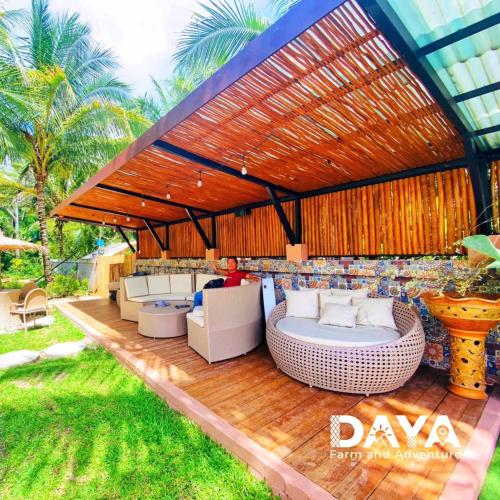 a patio with a couch and chairs on a wooden deck at Daya Farm and Adventure in Banay-Banay