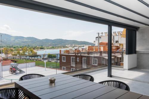 a view from the balcony of a house with a table and chairs at SithoniaRS Luxury 2nd Floor Roofgarden Apartment With Unique Seaview in Neos Marmaras