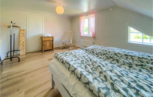 a bedroom with a bed and a wooden floor at 2 Bedroom Gorgeous Home In Hyltebruk in Hyltebruk