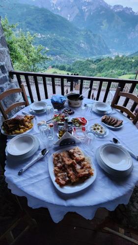 a table with plates of food on top of it at Bujtina Carku in Theth
