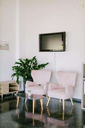 a living room with two chairs and a coffee table at Zephyros Hotel in Kos Town