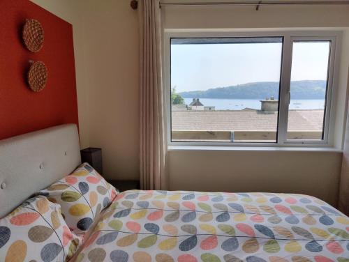 a bedroom with a bed and a large window at Crow's Nest Glandore - 3 - Self Catering in Glandore