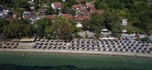 an aerial view of a park with umbrellas on the water at Enalion Hotel in Kala Nera