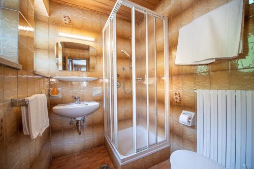 a bathroom with a sink and a shower and a toilet at Apartments Jasmin in Selva di Val Gardena