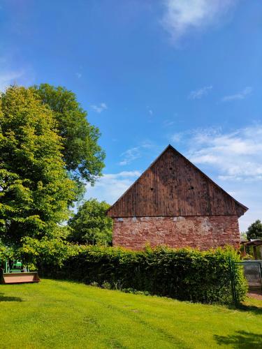 an old brick barn in the middle of a field at Apartmány Slavíkov - Simple Suite in Horní Radechová