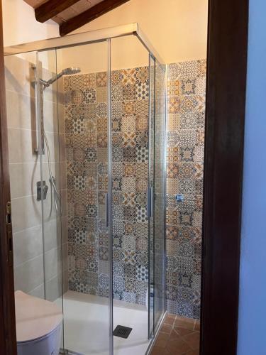 a glass shower in a bathroom with a toilet at Antica Colombaia in Volterra