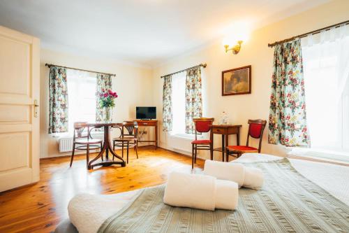 a living room with a bed and a table and chairs at Sv. Hubertus in Český Krumlov