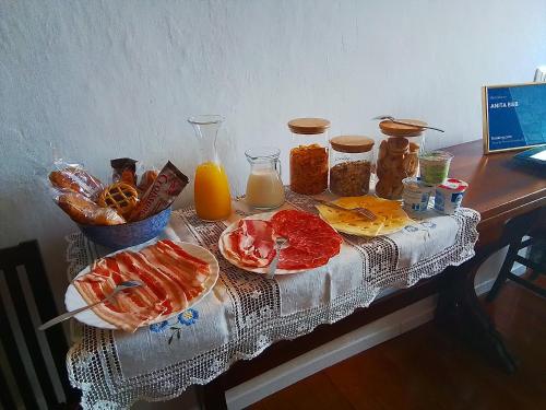 a table topped with plates of food and orange juice at ANITA B&B in Uscio