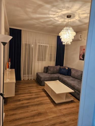 a living room with a couch and a table at Stan na dan Ilvento 2 in Vršac