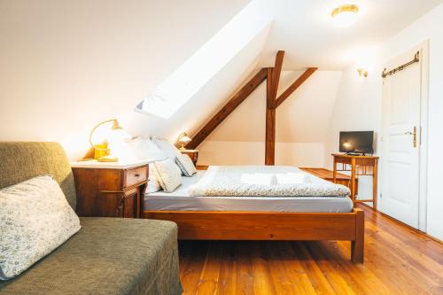 a bedroom with a bed and a couch at Sv. Hubertus in Český Krumlov