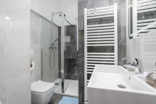 a bathroom with a toilet and a sink and a shower at Apartment Rukavina in Njivice