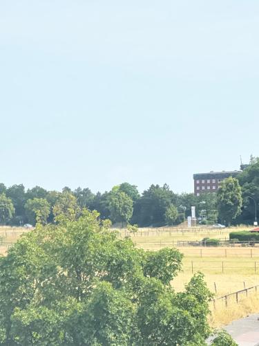 a view of a field with trees and a building at Ferienwohnung mit Loggia in Münster