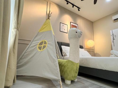 a bedroom with a bed with a tent and a stuffed llama at Ten Kinrara Puchong Bandar Kinrara in Puchong