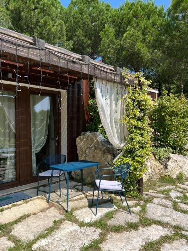 a blue table and two chairs on a patio at GreenValley BnB in Lapedona