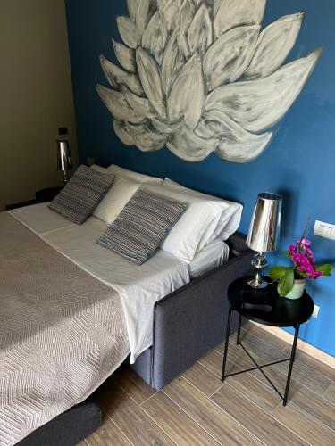 a bedroom with a bed with a painting on the wall at GreenValley BnB in Lapedona