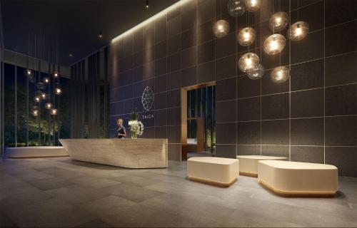 a lobby with two white stools and a building at Wentworth Point Oversized balcony view apartment in Sydney