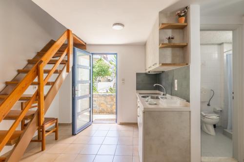 a bathroom with a staircase and a toilet in a room at Joanna Apartments in Agia Pelagia