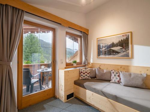 a room with a couch in front of a window at Landhaus Casper in Gerlos