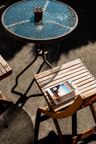 a table and a chair with a book on it at VILLA BRATTHOLMEN in Brattholmen