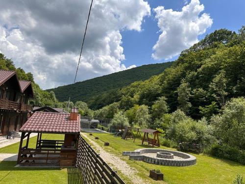 a garden with a gazebo and a playground at Relax and Smile Rameț in Biceşti
