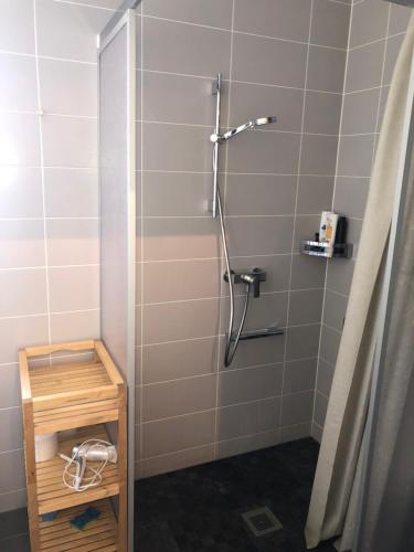 a bathroom with a shower with a wooden crate in it at One bedroom 3pieces entire Modern Appartment close to Airport, CERN, Palexpo, public transport to the center of Geneva in Meyrin