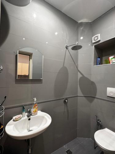 a bathroom with a sink and a mirror at Beach Apartaments Durres in Durrës