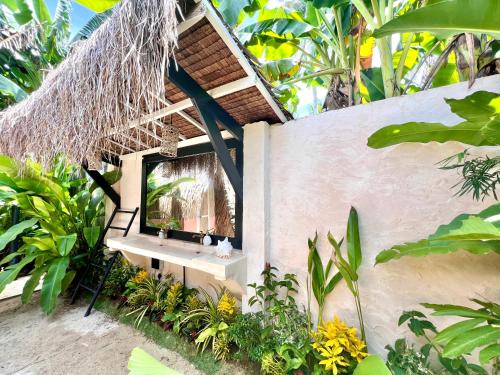 a small house with a sink and a mirror at Secret Pool Villa Tuason Beach in General Luna