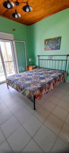 a large bed in a room with green walls at Tranquility Base in Neapoli Voion