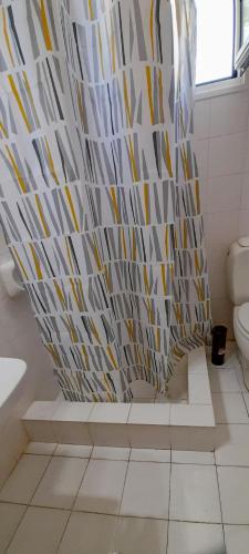 a bathroom with a shower with a shower curtain at Tranquility Base in Neapoli Voion