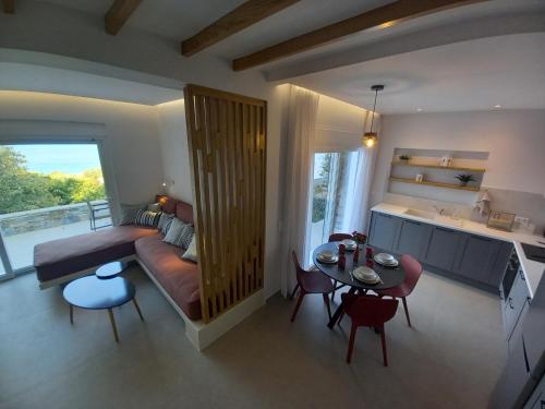 a living room with a couch and a table at Les Maisonettes in Kokkari
