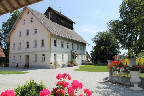 a large white building with flowers in front of it at Ruhige Ferienwohnung mit Balkon und Blick in die Natur in Bad Saulgau