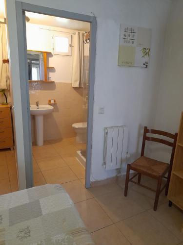 La salle de bains est pourvue d'un lavabo, de toilettes et d'une chaise. dans l'établissement Chambres d'Hôtes Chez Cécile à Lagnes, à Lagnes
