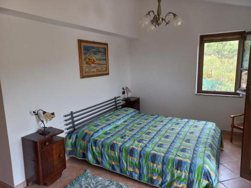 a bedroom with a bed with a colorful comforter at Villa Silvana in Terra Mala