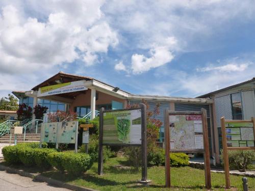 a building with several signs in front of it at belles chambres d'hôte, spacieuses et paisibles, en pays de Forcalquier in Saint-Étienne-les-Orgues