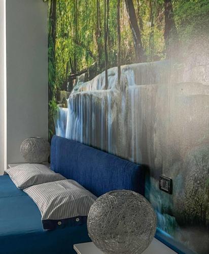 a room with a mural of a waterfall at B&B Le Principesse in Rossano Stazione