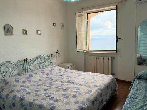 a bedroom with a bed and a window at Appartamenti Miramare in Collina in Ischia