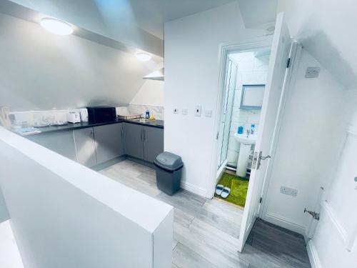 a kitchen with white walls and a white counter at Beautiful 1 bed apartment in Birmingham