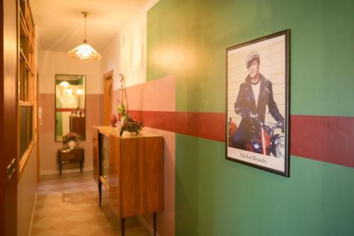 a hallway with a painting of a man on a wall at B&b Apartment 1970 in Lauria