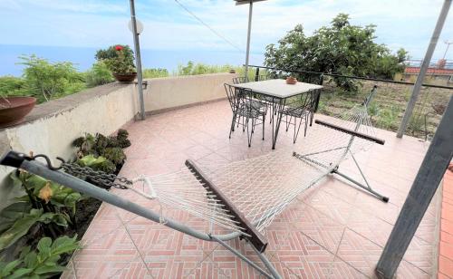 a patio with a table and chairs on a balcony at Appartamenti Miramare in Collina in Ischia