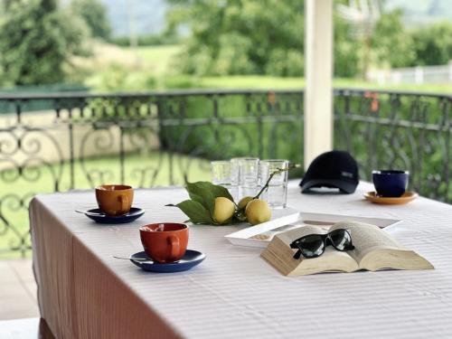 a table with two cups and a book on it at Casa con jardin - El Magnolio 7802 in Castillo