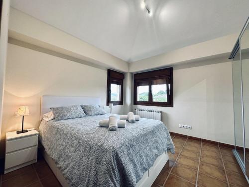 a bedroom with a bed with two pillows on it at Casa con jardin - El Magnolio 7802 in Castillo