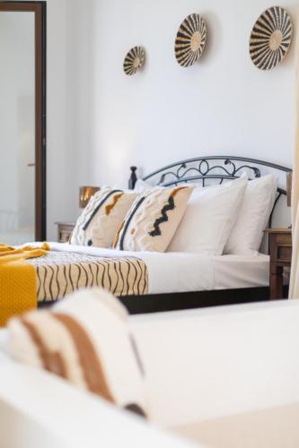 a bedroom with two beds with pillows at Anemomilos Beach hotel in Agia Anna Naxos