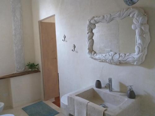 baño con lavabo y espejo en la pared en Villa Amai, en Lequio Tanaro