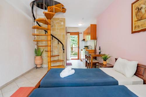 a bedroom with a blue bed and a spiral staircase at Erifili Kallithea in Kallithea Halkidikis