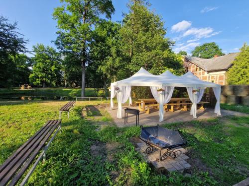 a gazebo with a grill in a yard at Hotel Kārklu Muiža in Jelgava