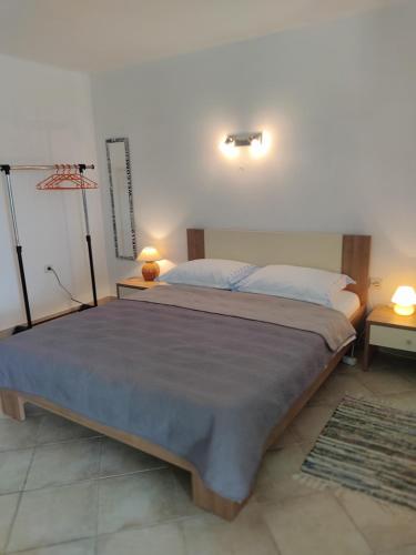 a bedroom with a large bed with two pillows at Cesarica Studio near sea in Cesarica