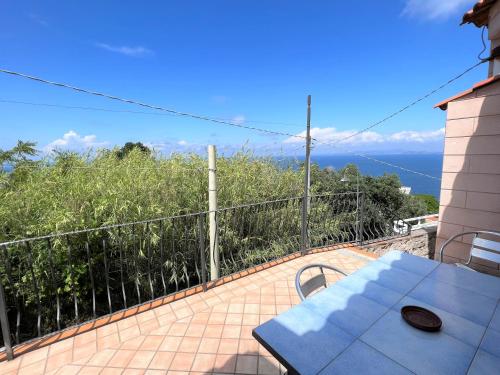 a balcony with a table and a view of the ocean at Appartamenti Miramare in Collina in Ischia
