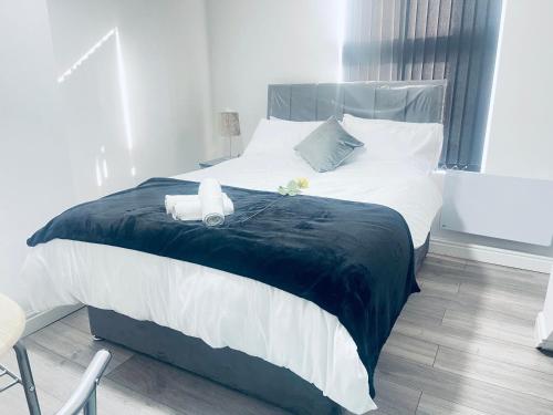 ein Schlafzimmer mit einem großen Bett mit zwei Handtüchern darauf in der Unterkunft Beautiful 1 bed apartment in Birmingham