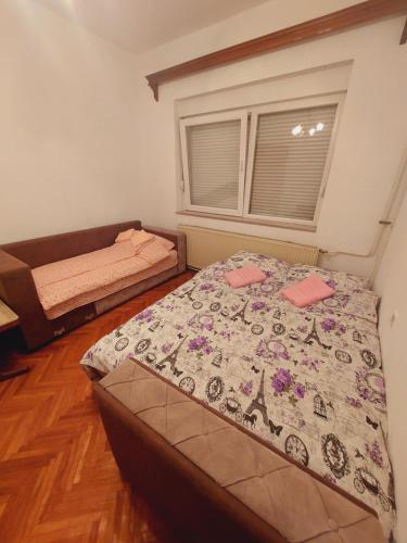 a bedroom with a bed with a quilt on it at Apartman Ena in Sjenica
