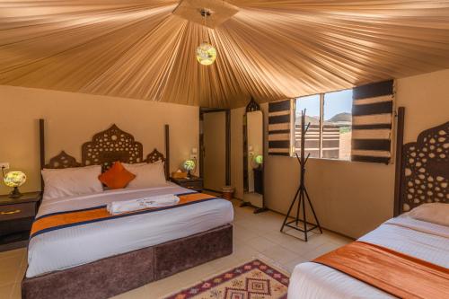 a bedroom with two beds in a room at Aladdin Camp in Wadi Rum